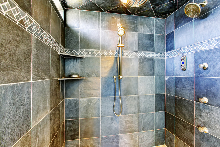 Remodeled shower with multiple showerheads and shower valves.