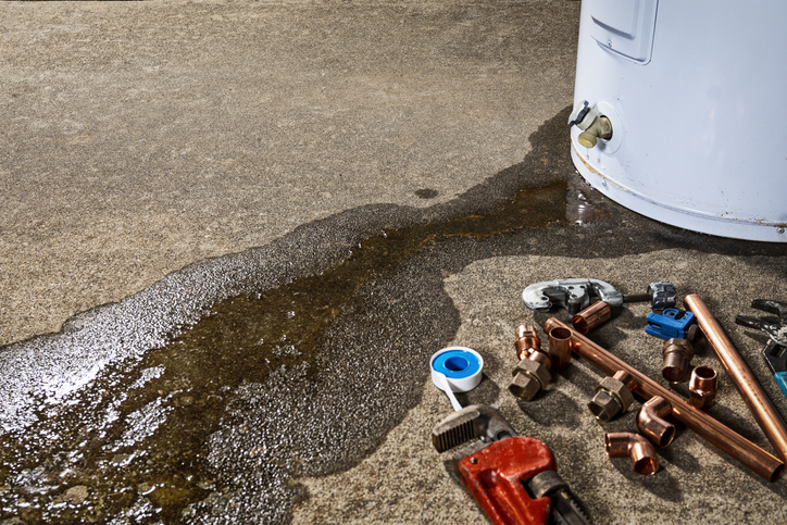 Leaky water heater being repaired.